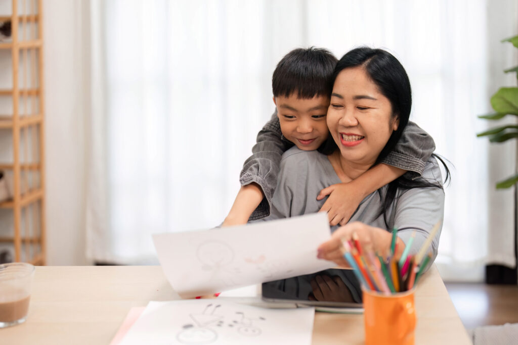 Child happy to share drawing with mom